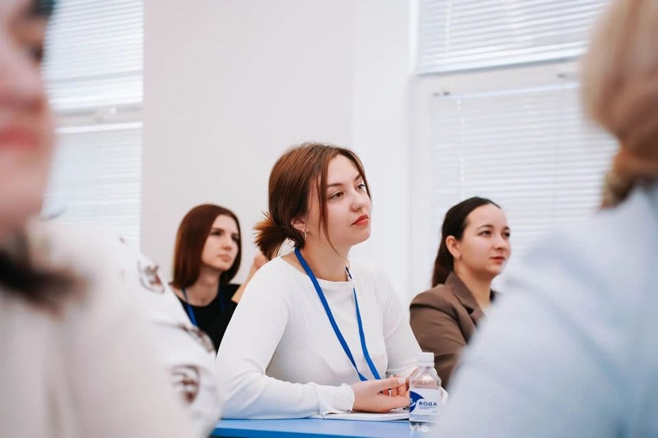 Участницы слушают выступление за столом